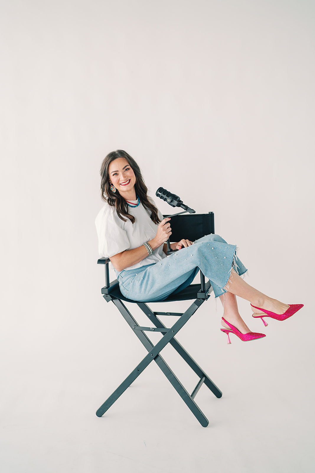 Lisa, RN, BSN, seated in a chair with a microphone
